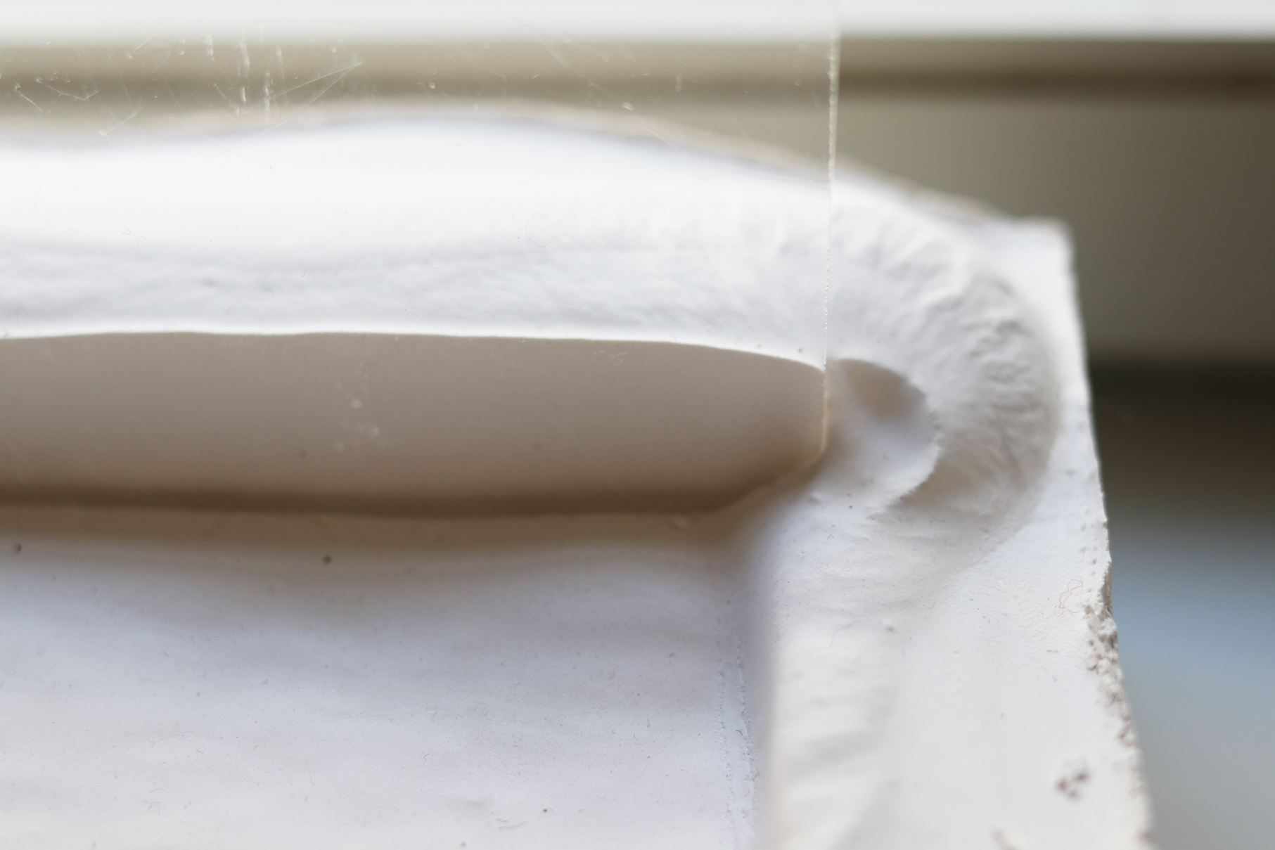 Experiment set-up of acrylic plate dragged through soft plaster