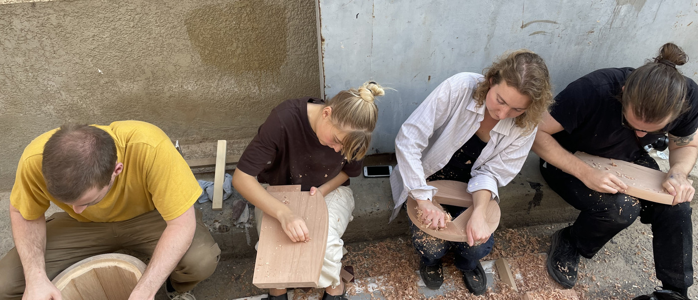 Four students working with wood
