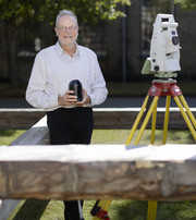 Laser scanner and total station - surrounded by an axe-hewn copy of one of the rafters from "Børsen"