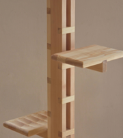 Close-up of a light-wood modular shelving system with adjustable shelves.