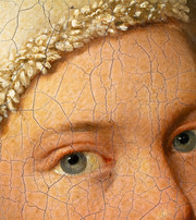 Detail of the eyes and forehead in an old painted portrait, showing pronounced craquelure and a measurement scale.