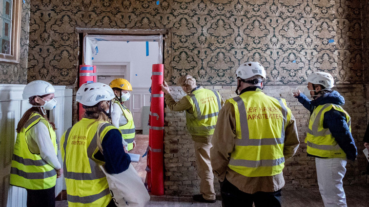 Studerende iført gule veste står i flok