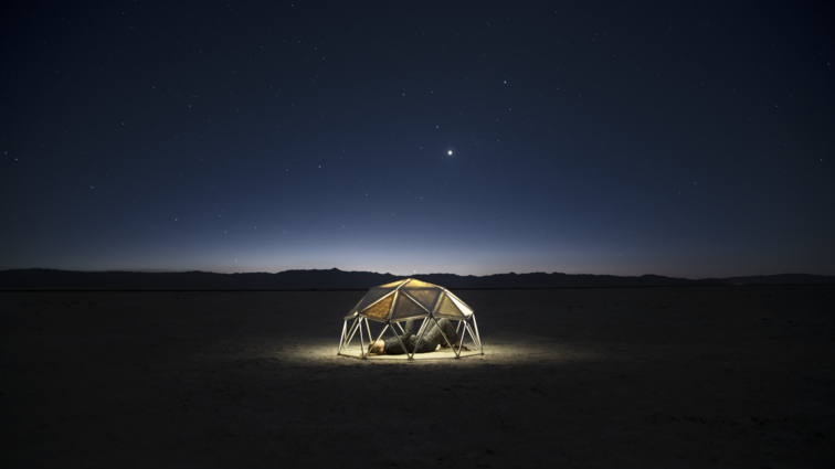 Dark night sky, transparent dome structure.