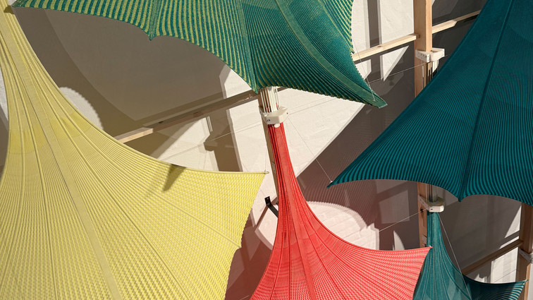 Five colorful, stretched textile surfaces in shades of green, yellow, red and blue.