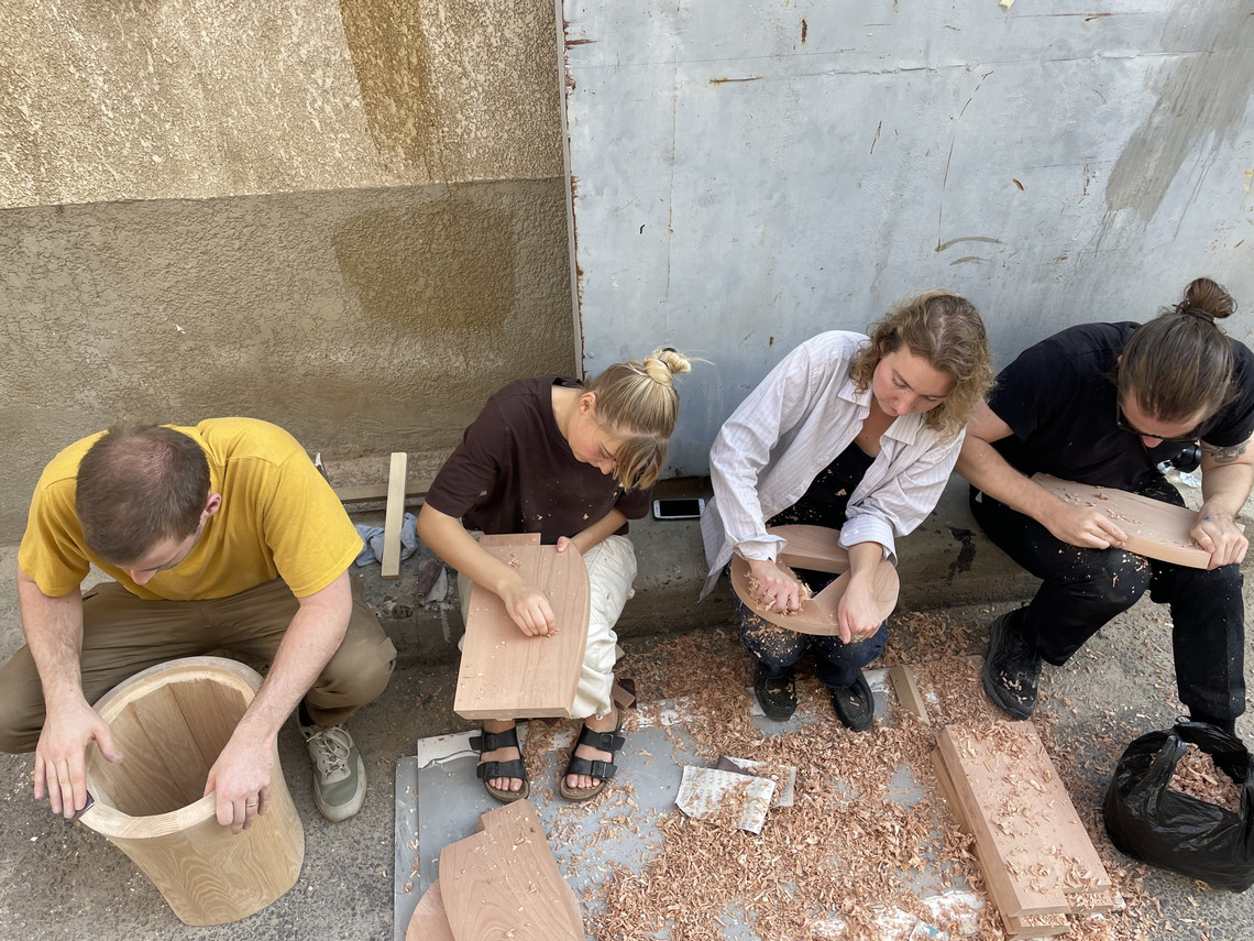 Four students working with wood