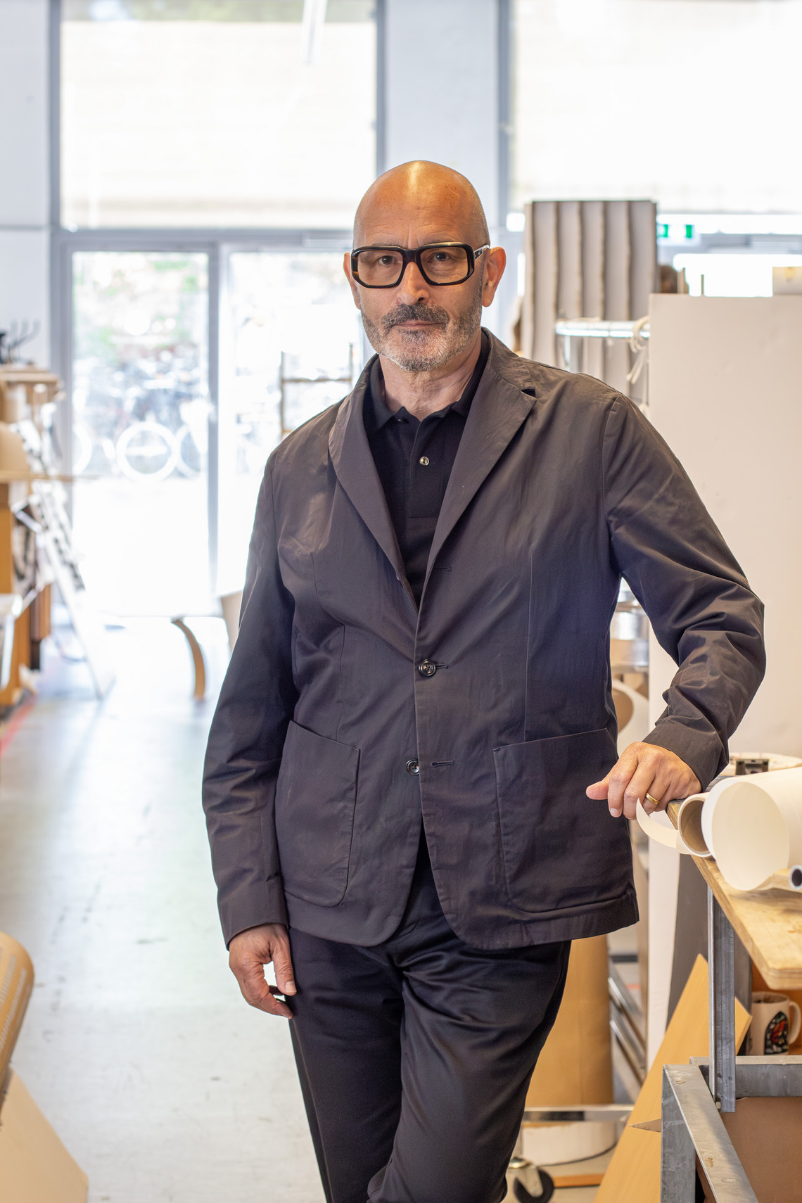 Nicholas Rhodes standing by workdesk