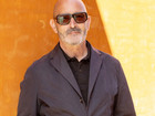 Nicholas Rhodes in front of ochrecolored wall