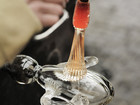 Molten glass being shaped on a rod in a workshop.