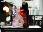 Colored glass sculpture displayed on a table in a studio.