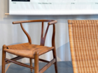Wooden chair with woven seat and a woven lounge chair in front of a sustainable furniture design chart.