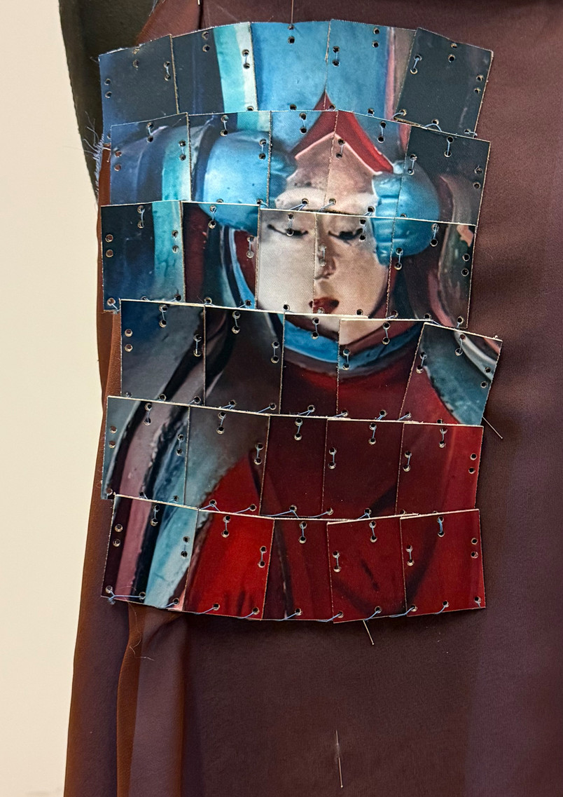 Textile sample integrating the image of the Face-Tearing Wisdom King into an armour-inspired construction, where fragmented and reconstructed layers translate temple imagery into a protective surface.