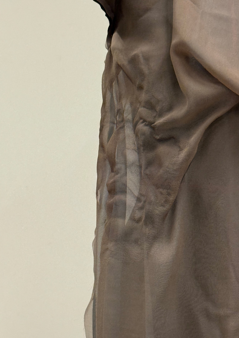 Close-up detail of relief-like Luohan faces created on lightweight silk fabric, suggesting different inner emotions and states carried within the body.