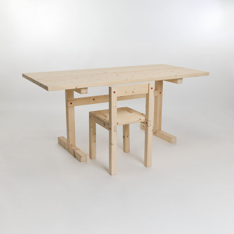 A light wooden table and chair set made from reclaimed pine, photographed against a plain white background.