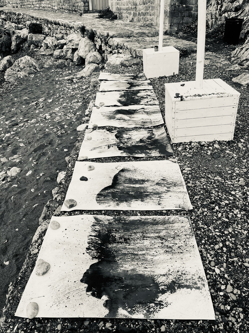 graphite wave drawings on pebble beach on Hydra 2025