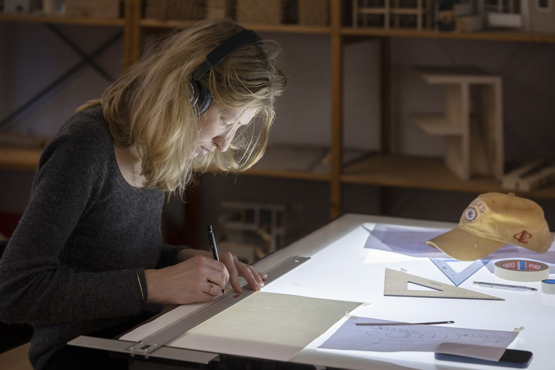 Student drawing at light table 