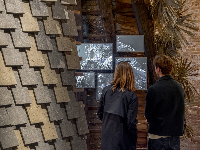 Two people looking at screen in pavillon 