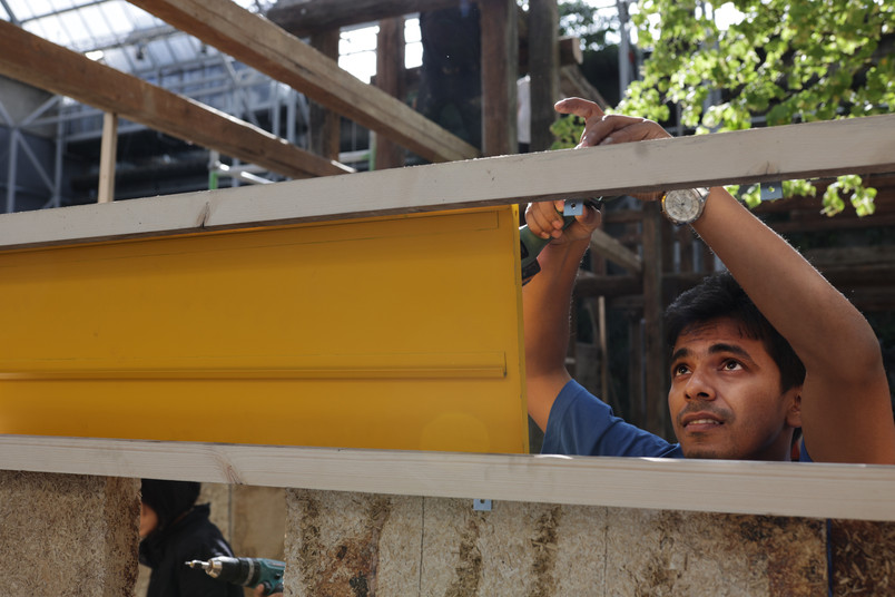 A man building a pavilion wall