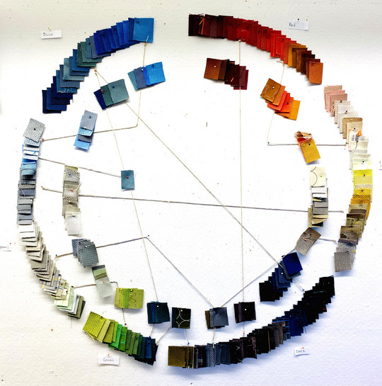 Textile samples in many colors arranged in circle