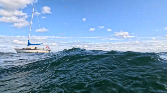 Sea and white sail boat