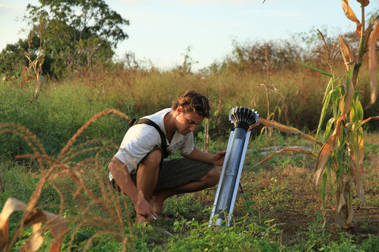 Fieldwork with a technical device placed in agricultural soil.