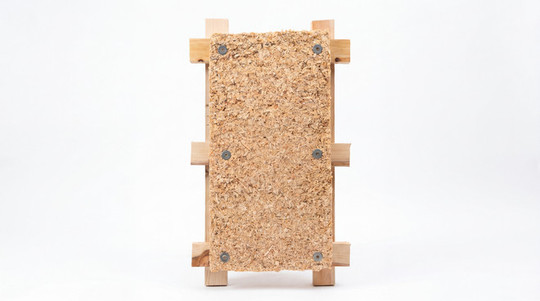 Rectangular wood-chip panel mounted on a simple wooden frame.