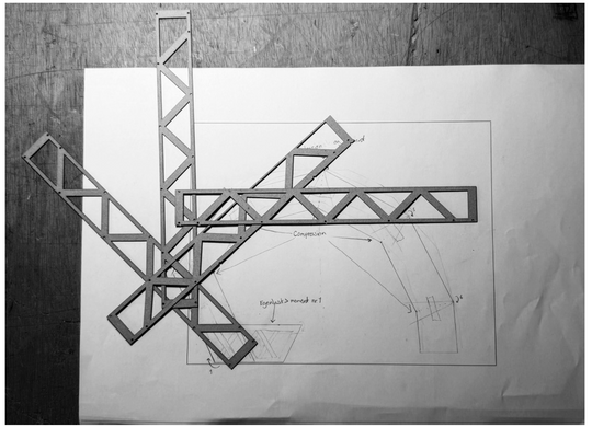 Three close-up images of cut-out lattice elements with triangular and diamond-shaped openings and their shadows.