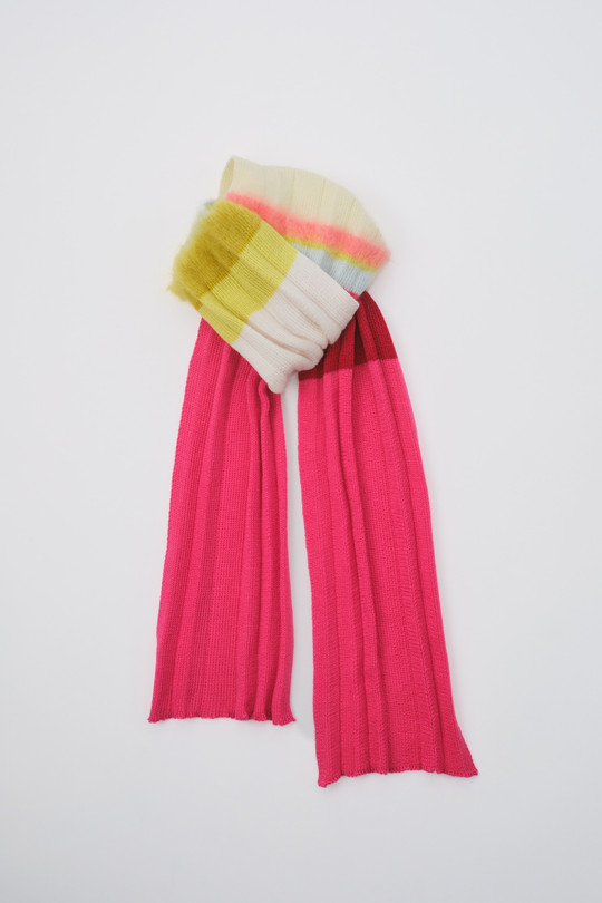 Long pink knitted scarf with pale yellow, white and light blue details at the top