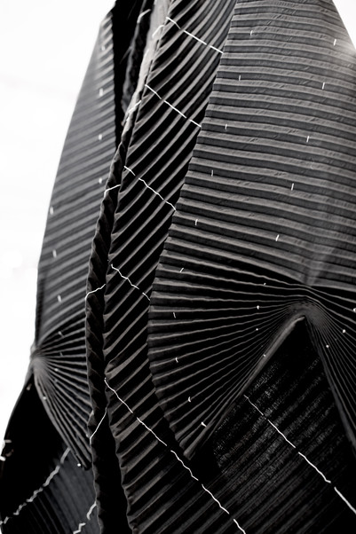 Black pleated and draped fabric