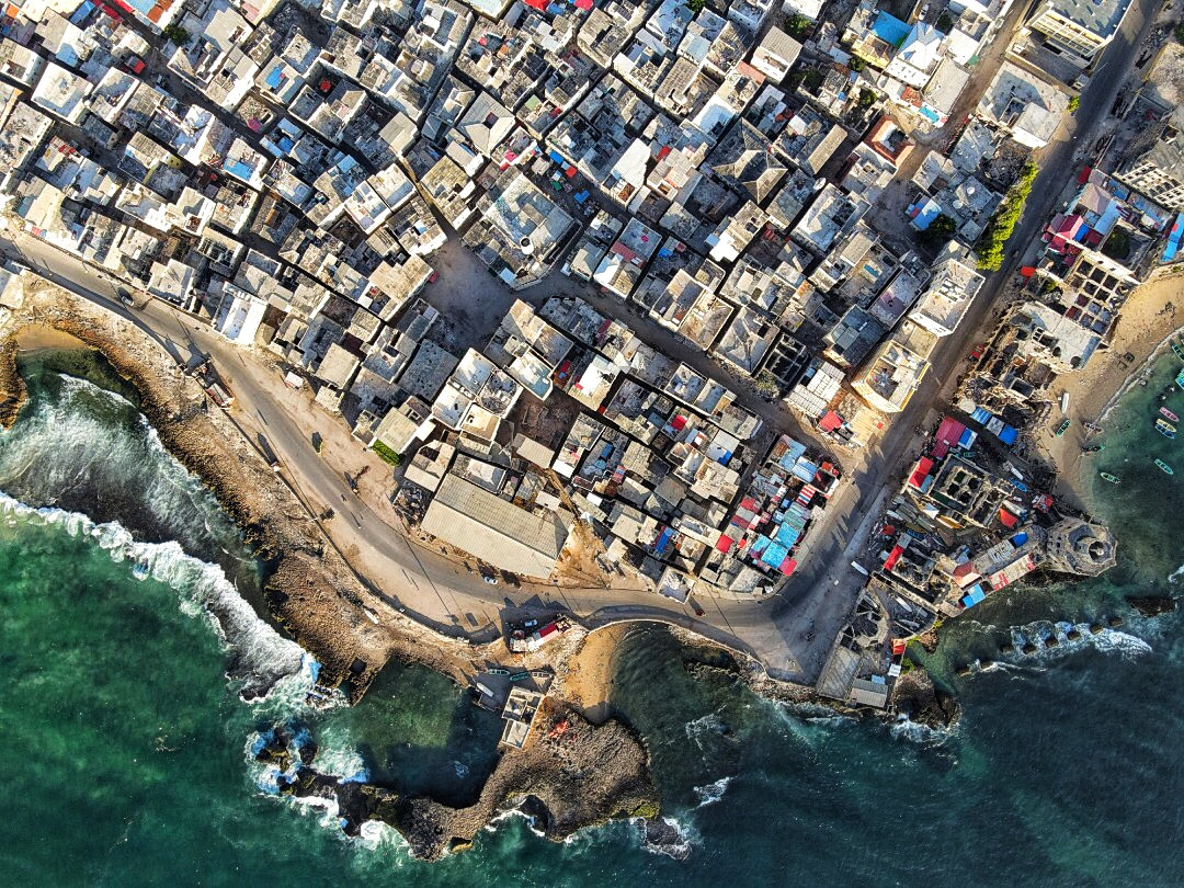 Aerial view of dense buildings by the coast.