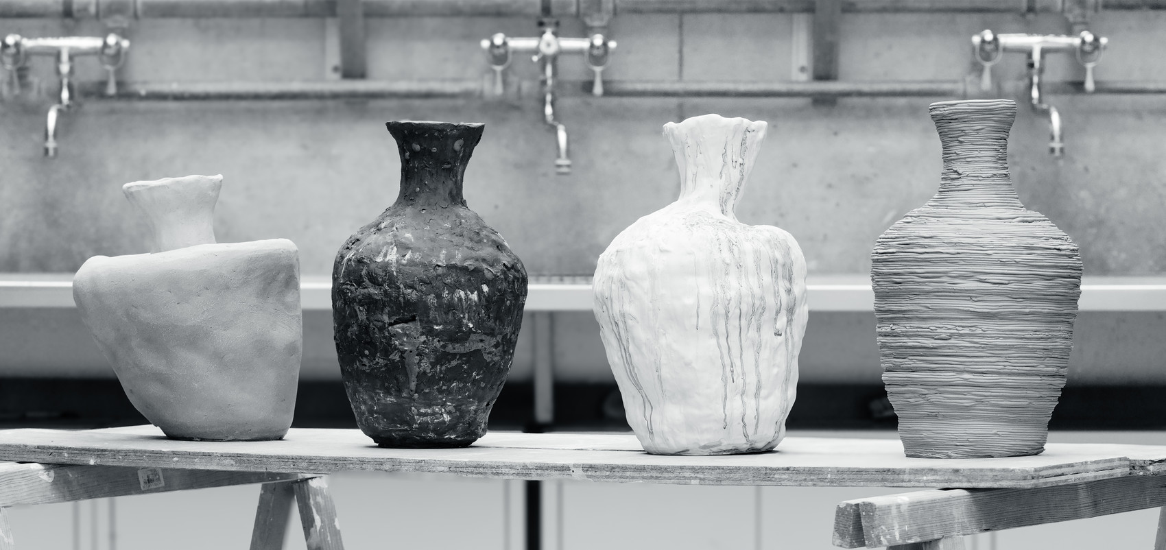 Four pieces standing next to each other in a line, black and white